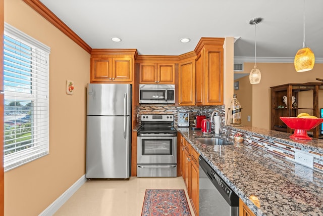 kitchen featuring hanging light fixtures, sink, backsplash, appliances with stainless steel finishes, and dark stone countertops