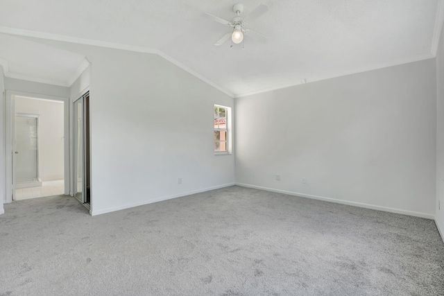 unfurnished room with ceiling fan, light carpet, and vaulted ceiling