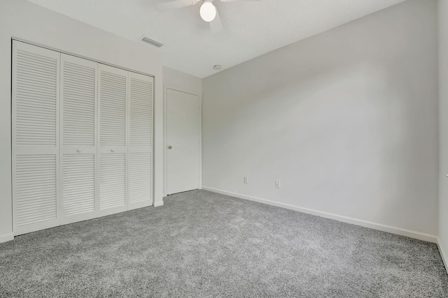 unfurnished bedroom with ceiling fan, carpet floors, and a closet