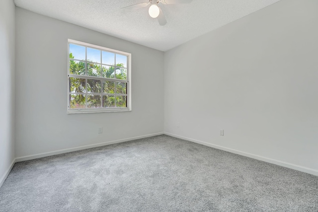 unfurnished room featuring carpet, ceiling fan, and a textured ceiling