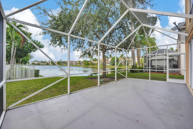 unfurnished sunroom featuring a water view