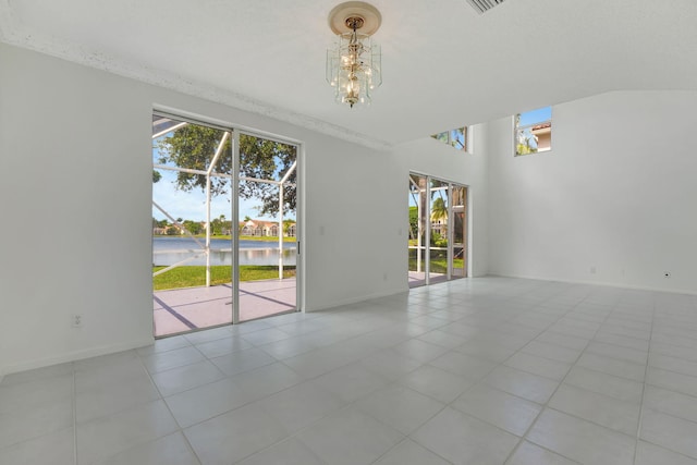 unfurnished room with a wealth of natural light and light tile patterned floors