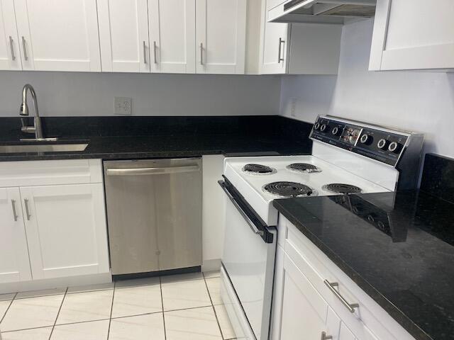 kitchen with dishwasher, ventilation hood, white cabinets, light tile patterned floors, and white electric stove