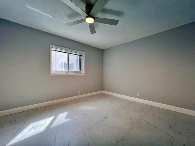 unfurnished room featuring ceiling fan and a textured ceiling