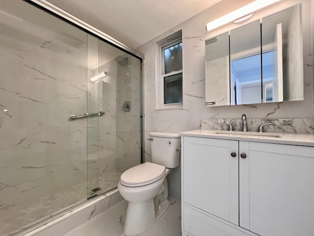 bathroom with walk in shower, vanity, and toilet