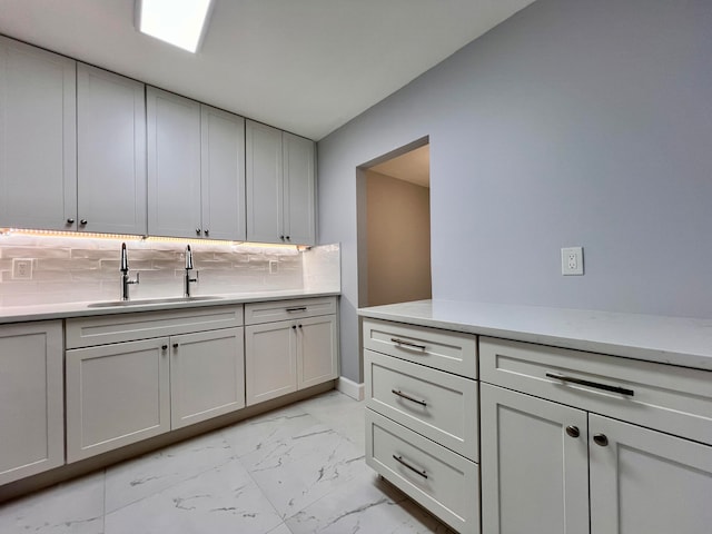 kitchen featuring backsplash and sink