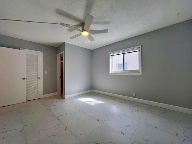 spare room with ceiling fan and a textured ceiling