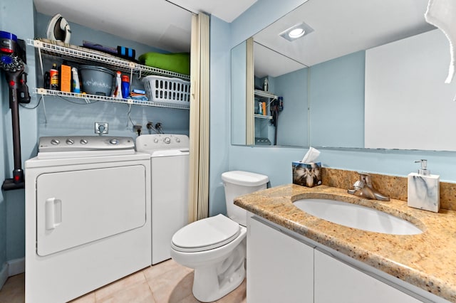 bathroom with tile patterned floors, vanity, toilet, and independent washer and dryer