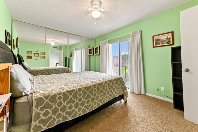 bedroom featuring ceiling fan, a closet, carpet, and a textured ceiling