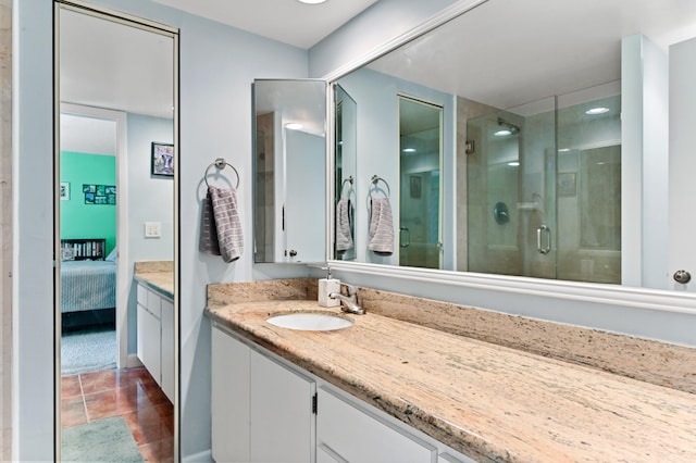 bathroom featuring vanity and a shower with door