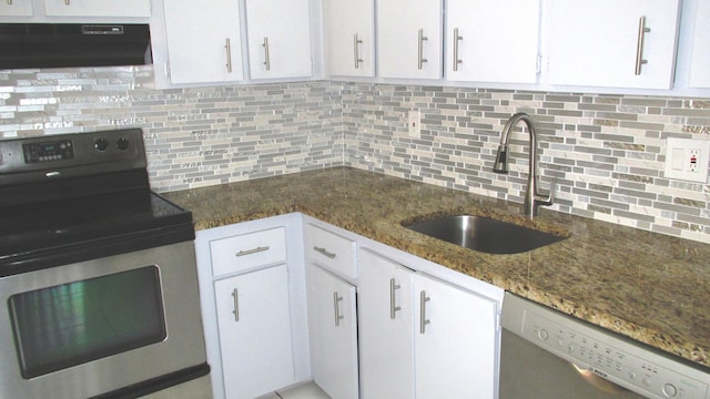 kitchen featuring white cabinetry, stainless steel appliances, extractor fan, and a sink