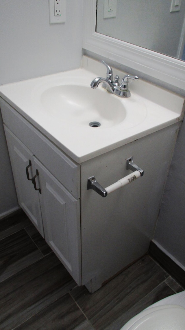 bathroom with vanity and hardwood / wood-style flooring