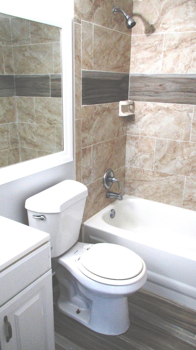 full bathroom featuring toilet, shower / bathtub combination, and vanity