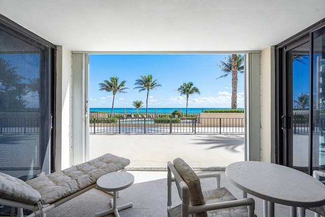 interior space featuring a water view and a balcony