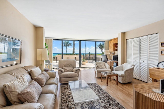 living room with light hardwood / wood-style flooring and floor to ceiling windows