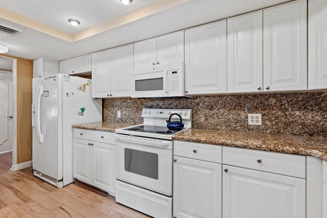 kitchen featuring white cabinets, light hardwood / wood-style floors, and white appliances