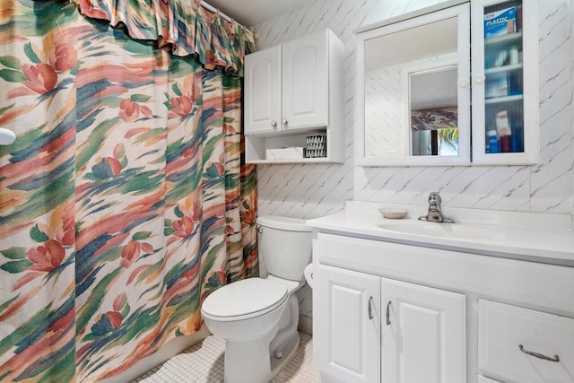 bathroom with tile patterned floors, vanity, and toilet