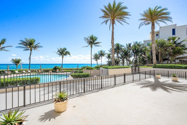 view of patio / terrace featuring a water view and a community pool