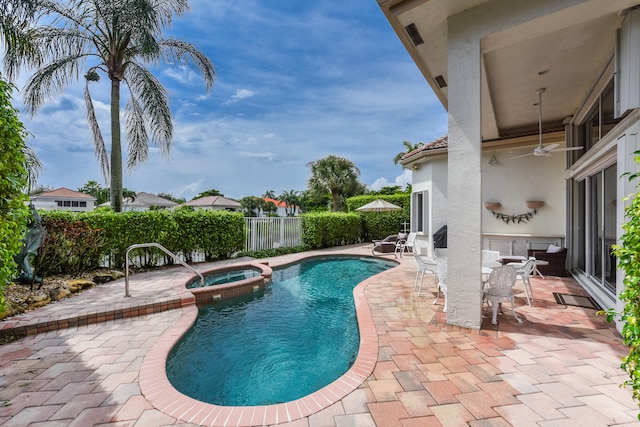 view of swimming pool with an in ground hot tub, a patio, and ceiling fan