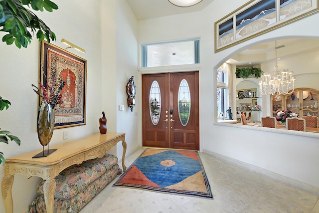 foyer entrance featuring a high ceiling and an inviting chandelier