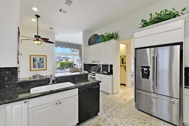 kitchen featuring white appliances, a breakfast bar, sink, kitchen peninsula, and white cabinets