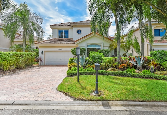 mediterranean / spanish-style home with a front lawn