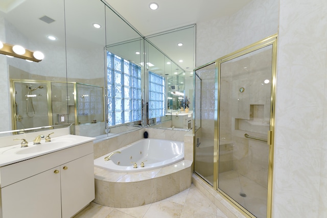 bathroom featuring vanity and independent shower and bath