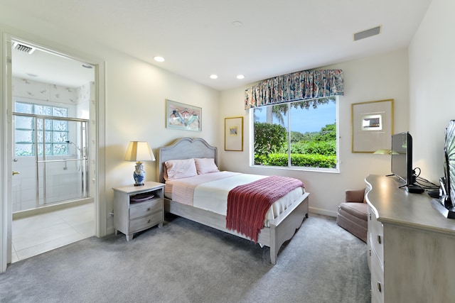 bedroom with ensuite bathroom and carpet