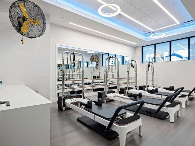 exercise room with wood-type flooring