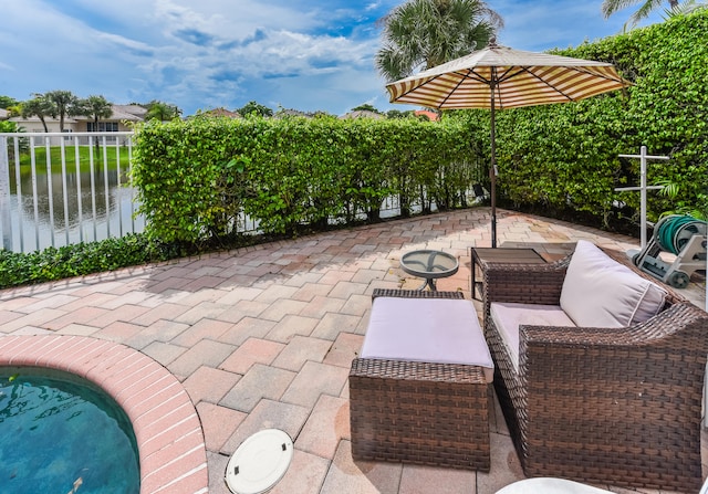 view of patio with a water view