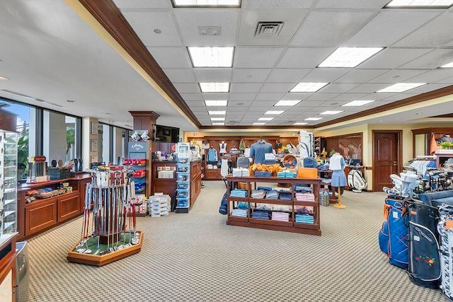 miscellaneous room featuring a paneled ceiling and light colored carpet