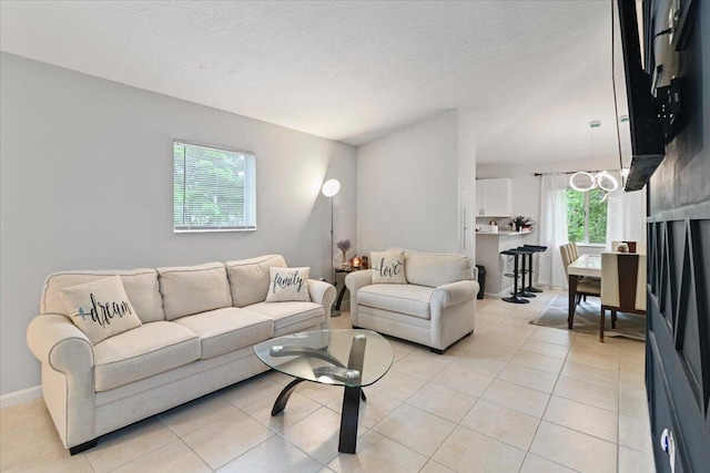 tiled living room with a wealth of natural light and a textured ceiling