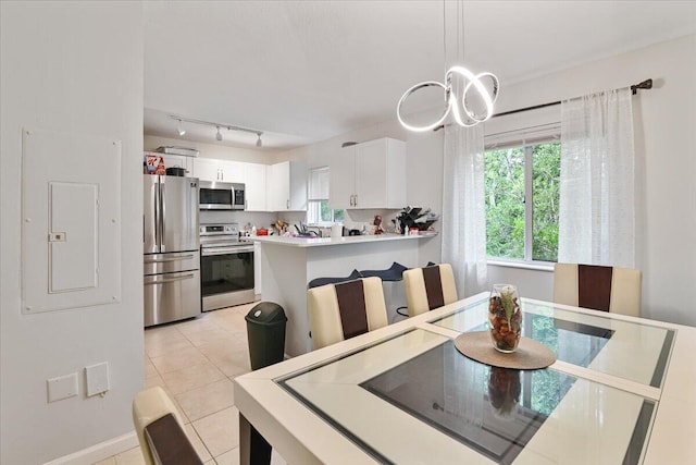 tiled dining area with electric panel and rail lighting