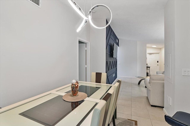 tiled dining room with a textured ceiling