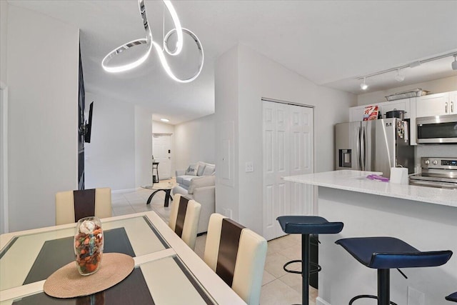 tiled dining area with rail lighting