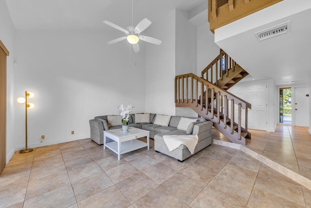 tiled living room featuring a high ceiling and ceiling fan