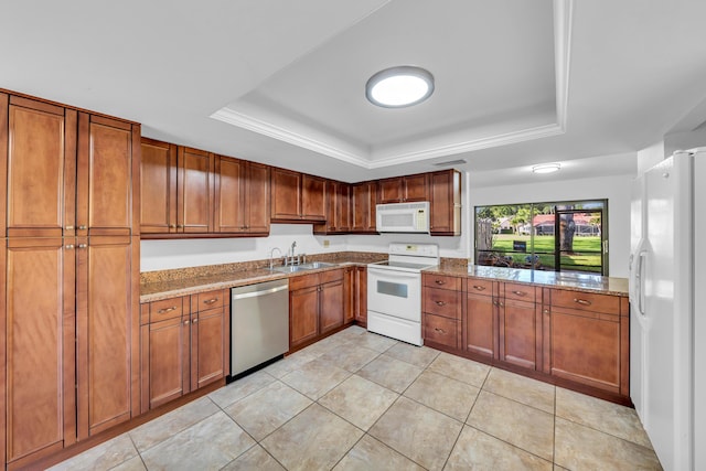 kitchen featuring white appliances, a tray ceiling, light stone countertops, and sink