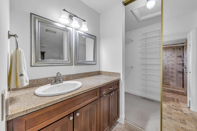 bathroom featuring vanity and a tile shower