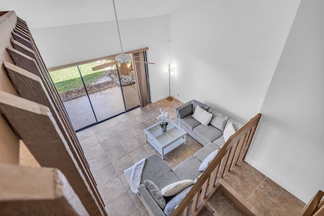 living room with ceiling fan, light tile patterned floors, and high vaulted ceiling