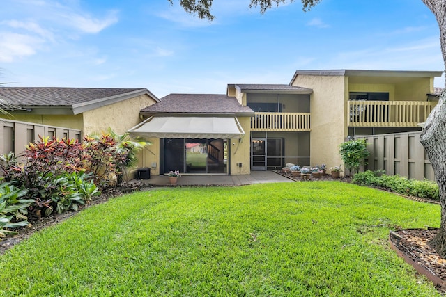 rear view of property with a patio area and a lawn