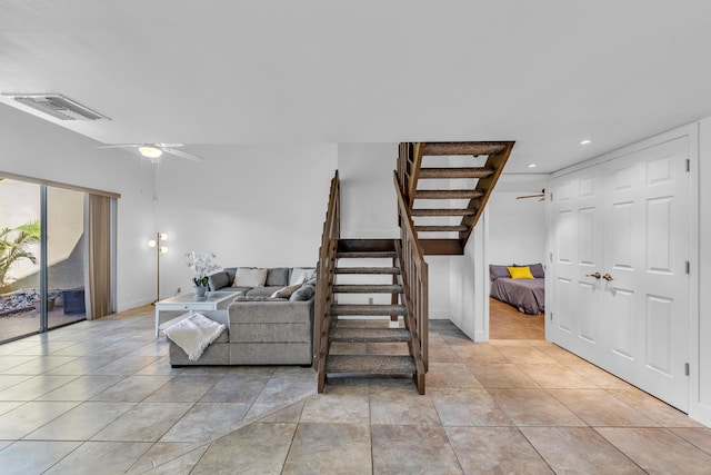 tiled living room with ceiling fan