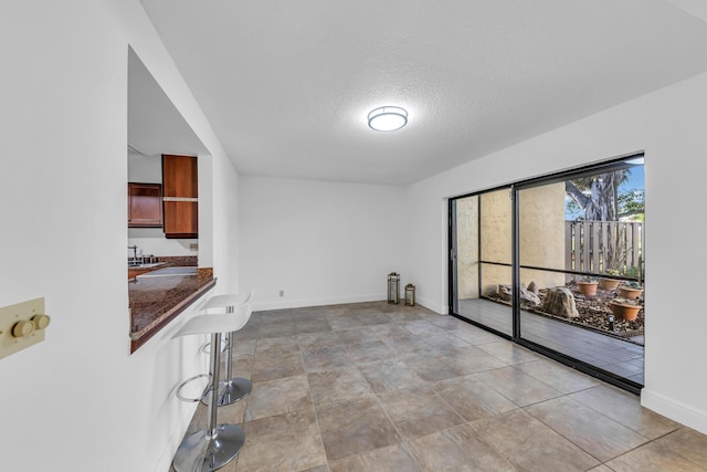 interior space featuring sink and a textured ceiling