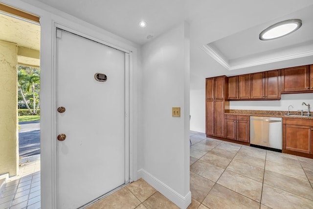 kitchen featuring sink, stainless steel dishwasher, and light tile patterned floors