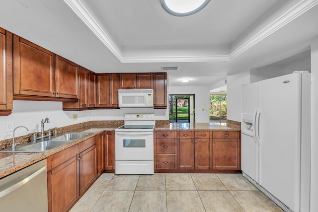 kitchen featuring light tile patterned flooring, sink, a raised ceiling, light stone countertops, and white appliances