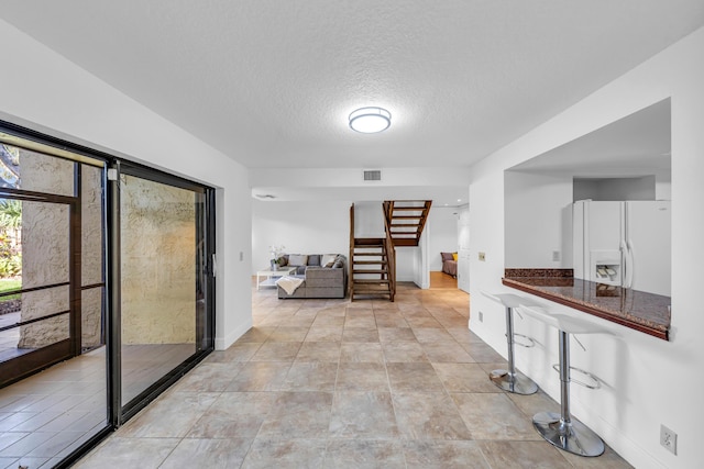 hallway featuring a textured ceiling