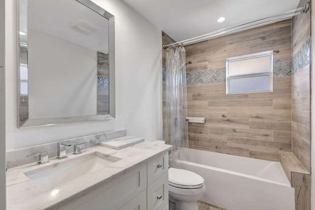 full bathroom with vanity, shower / bath combo, and toilet