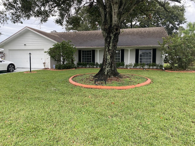 single story home featuring a garage and a front lawn