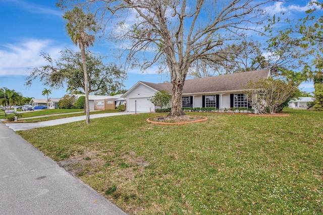 single story home featuring a garage and a front lawn