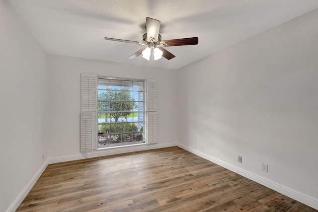 unfurnished room featuring ceiling fan and hardwood / wood-style floors