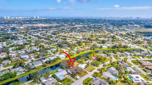 birds eye view of property with a water view